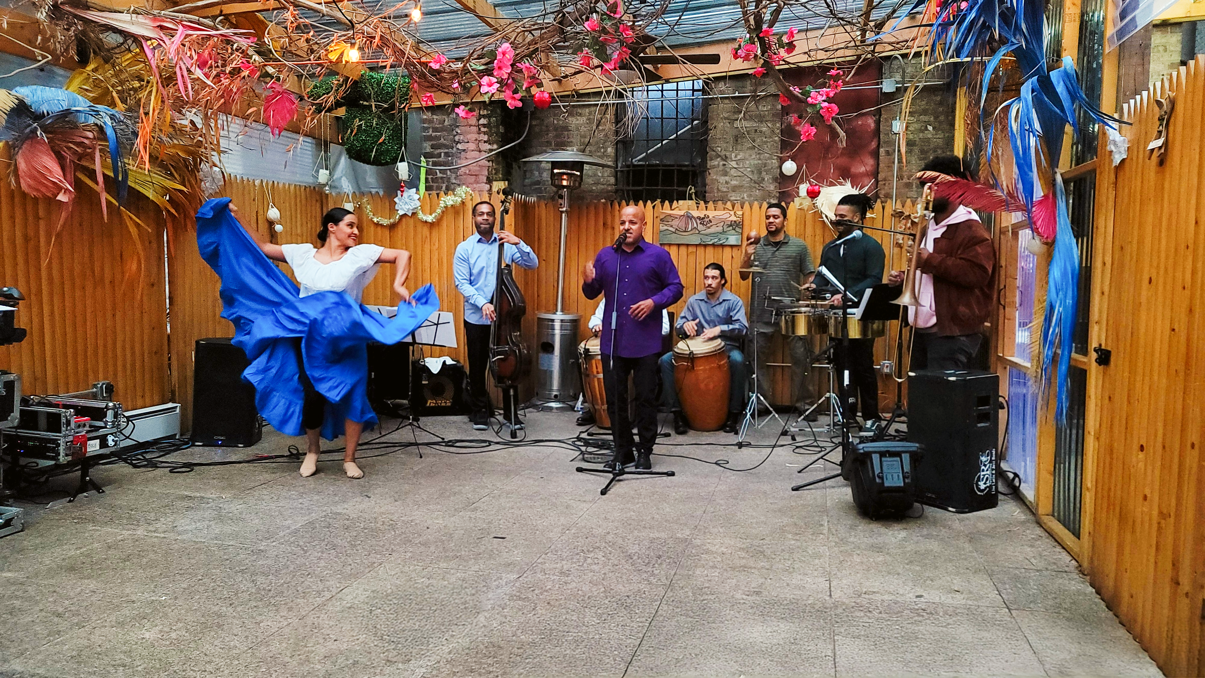 Los Pleneros de la 21 performing with dancer Miriam Gallardo lifting her blue skirt