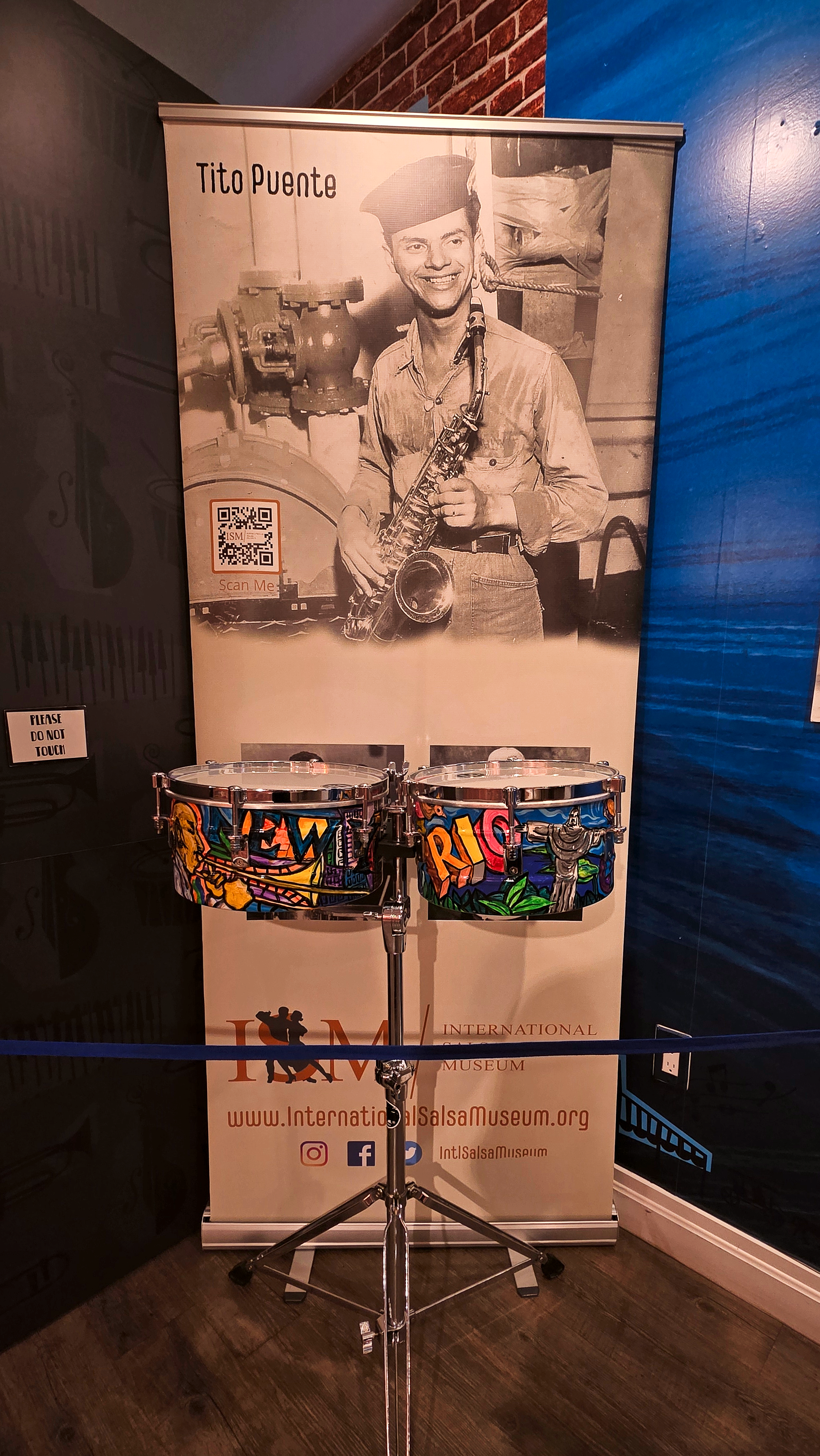 Tito Puente exhibition display with colorful timbales