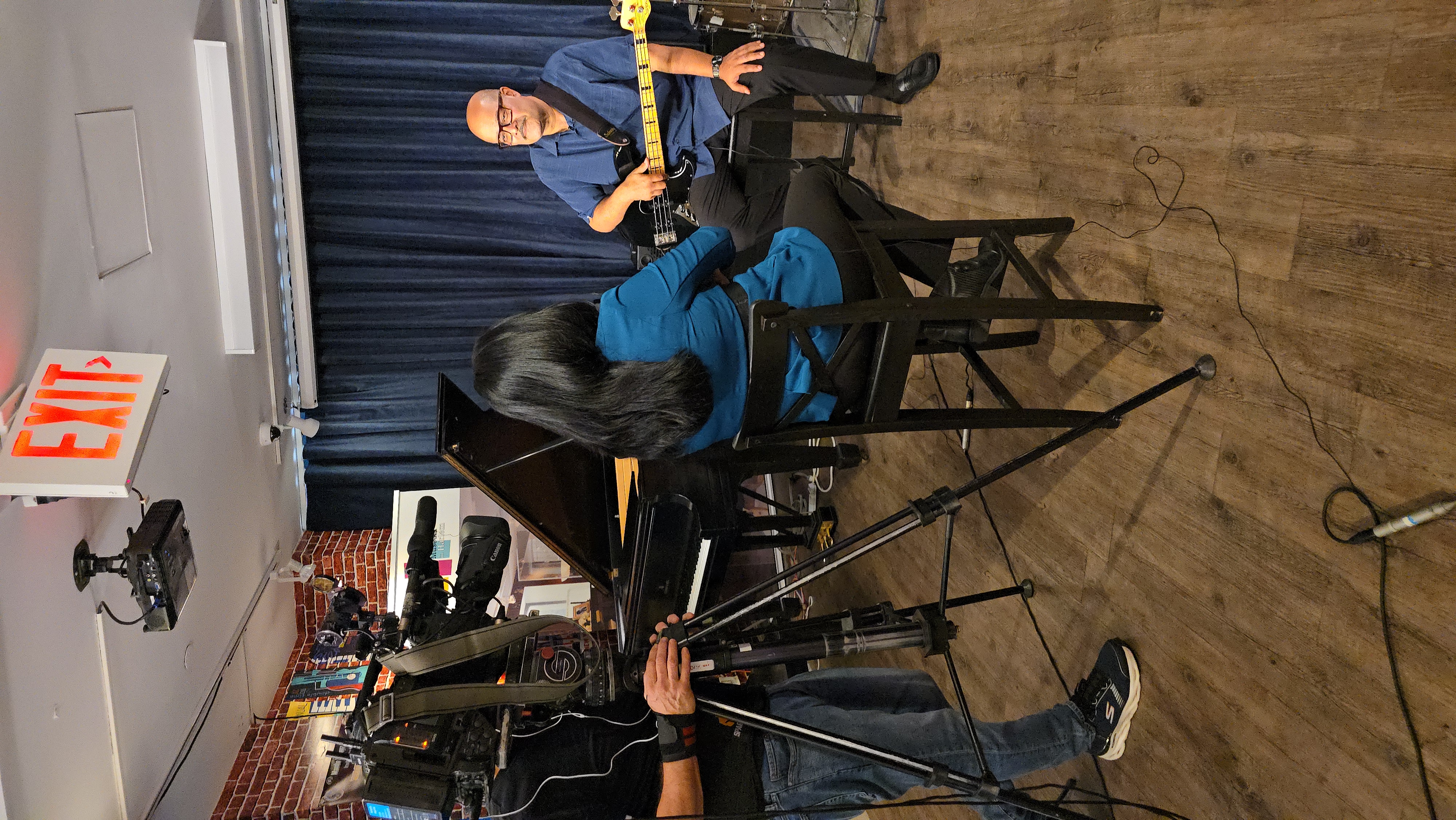 Reporter Grace Gomez interviews bass player Ruben Rodriguez at the museum